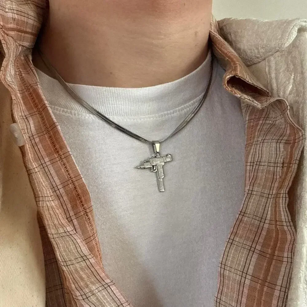 Flat lay silver uzi pendant